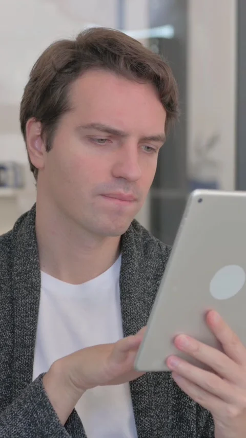 Portrait of Casual Young Man Working on Digital Tablet, vertical video Video stock 324792973