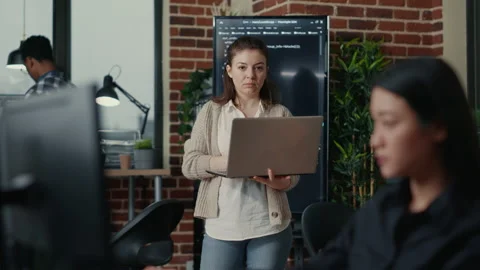 Portrait of caucasian app developer holding laptop looking up and smiling Stock Footage 168233885