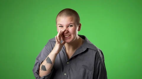 Portrait of caucasian non binary gender fluid woman 20s looks around put hand to Stock Footage 223352680