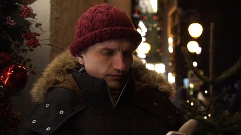 Portrait of caucasian young man using smartphone on a busy urban street at night Stock Footage 83917407