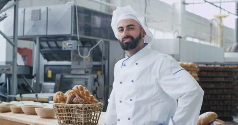 Portrait of charismatic baker man with beard smiling pretty in front of the Video stock 112139127