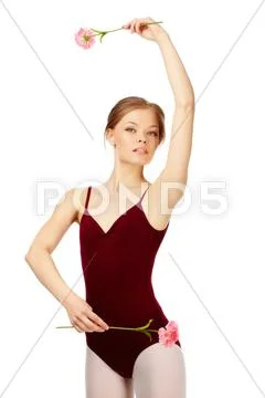 Portrait of charming ballerina with fresh carnations looking at camera Stock Photos
