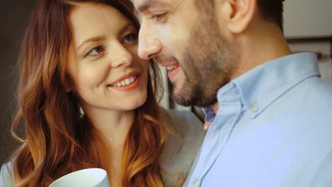 Portrait of charming couple of young woman holding cup of coffee in hand and her Stock Footage