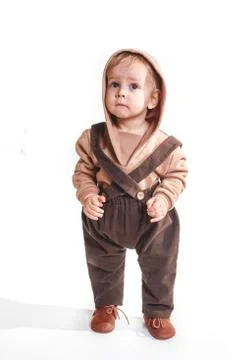 Portrait of a charming one-year-old little boy on a white background, dressed Stock Photos