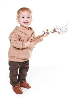 Portrait of a charming one-year-old little boy on a white background, dressed Stock Photos