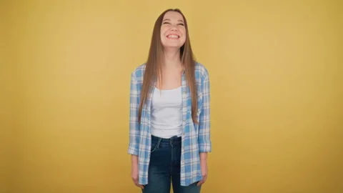 Portrait of a charming young adult in a checkered girl shirt on yellow Stock Footage 150521953
