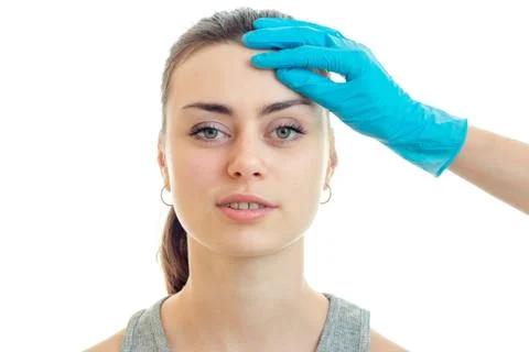 Portrait of a charming young girl without makeup at the doctor in blue gloves Stock Photos