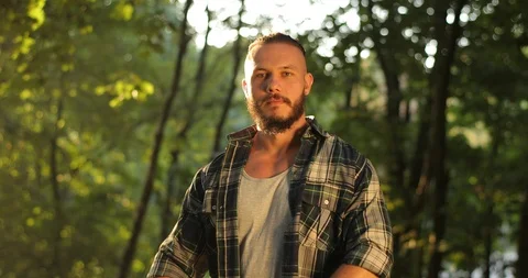Portrait of charming young man smiling close up of fit attractive man in forest Stock Footage 126497057