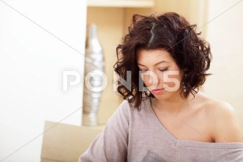 Portrait of a charming young sad woman at home Stock Photos