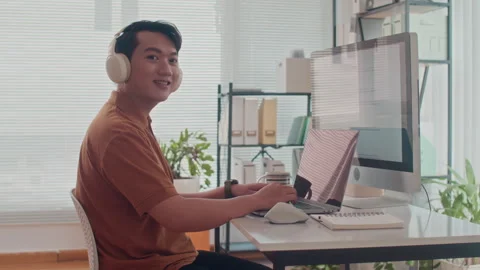 Portrait of Cheerful Asian Coder Developing App on Computer Video stock 265070276