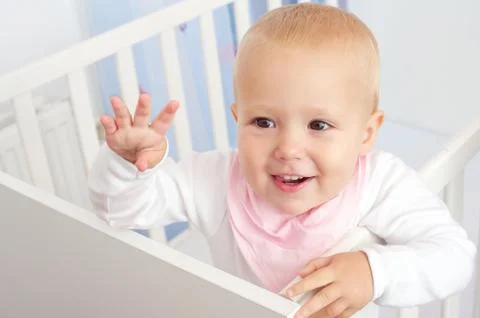 Portrait of a cheerful baby waving hello Stock Photos