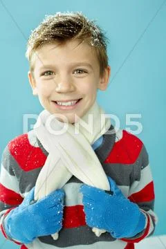 Portrait of cheerful boy in warm clothing looking at camera and smiling Stock Photos
