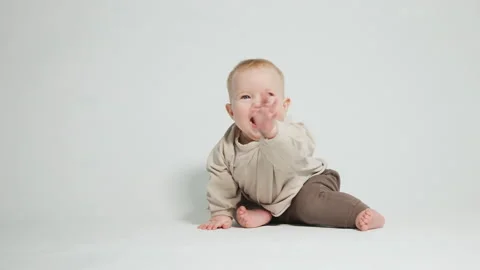 Portrait of a cheerful child, on a light studio background Stock Footage 242770522
