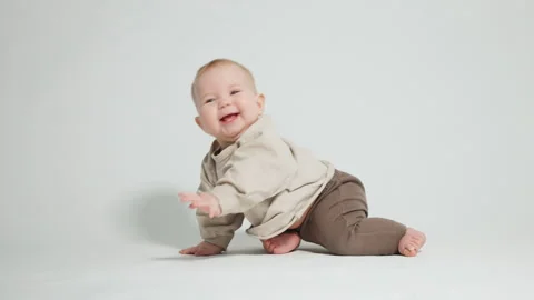 Portrait of a cheerful child, on a light studio background Stock Footage 242771032