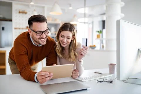 Portrait of a cheerful couple shopping online. Technology, e-commerce, banking Stock Photos