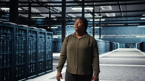 Portrait of cheerful data center engineer conducting security audits Stock Photos