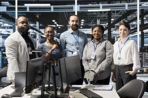 Portrait of cheerful engineering team in data center running scripts Stock Photos