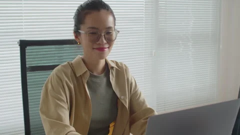 Portrait of Cheerful Female Coder Working on Laptop in Office Stock Footage 256980584