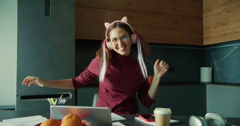 Portrait of a cheerful girl Student with bright hair in pink headphones dancing Stock Footage 299941953