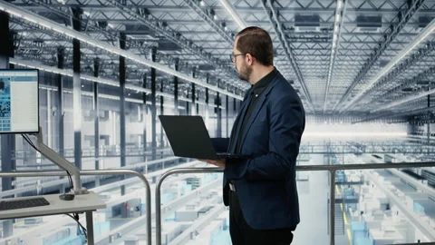 Portrait of cheerful man looking at data on laptop, improving microchips Stock Footage 333379229