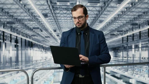 Portrait of cheerful man looking at data on laptop, improving microchips Stock Footage 333383712