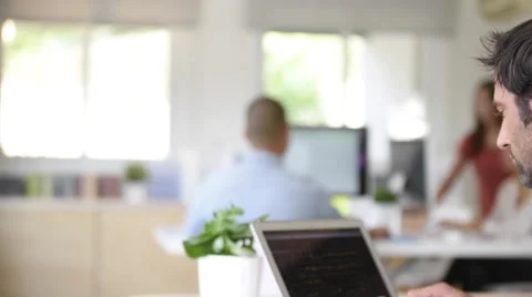 Portrait of cheerful man in office working on laptop Stock Footage 68200601