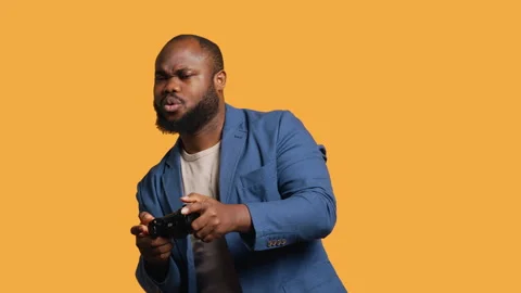 Portrait of cheerful man playing videogames with controller, studio background Stock Footage 272711596