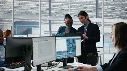Portrait of cheerful multiethnic team examining microchip circuit layouts Stock Footage 335877748