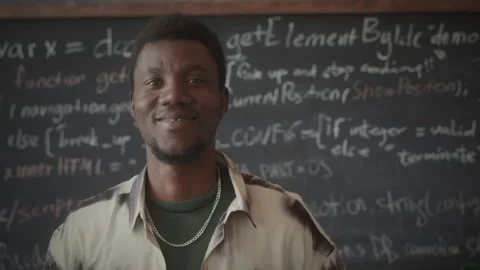 Portrait of Cheerful Programmer against Chalkboard with Computer Code Stock Footage 263733880