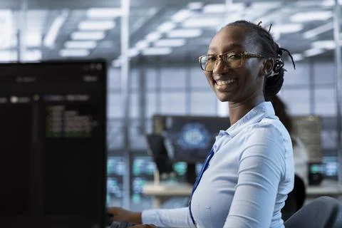 Portrait of cheerful woman tasked with doing checkup on server room 스톡 사진