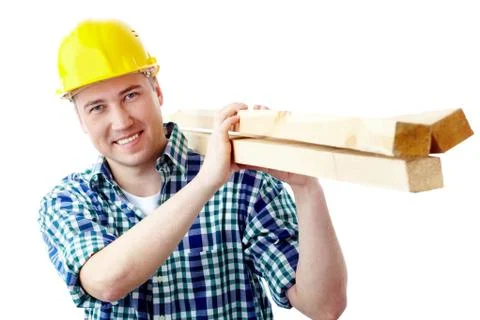 Portrait of a cheerful worker in helmet carrying lumber Stock Photos