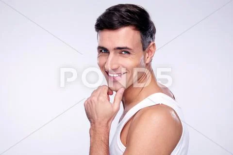 Portrait of a cheerful young man over gray background Stock Photos
