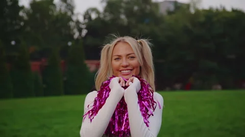 Portrait of cheerleeder in action. Medium shot smiley cheerleader outside Stock Footage 167658966