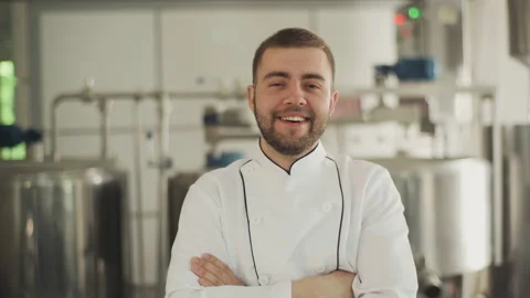 Portrait of a cheese factory worker. The technologist in a white coat looks at Vidéo 175436087