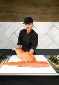 Portrait of chef standing with salmon fish. Chef cutting fish and making sashimi Stock Photos