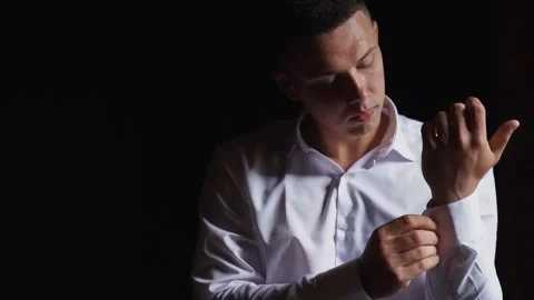 Portrait of a chic guy in a white shirt in a dark interior. Sexy man near window Stock Footage 242427557