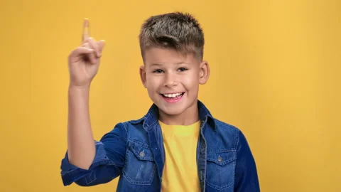 Portrait child boy smiling pointing forefinger having good idea solving problem 動画素材 165867950