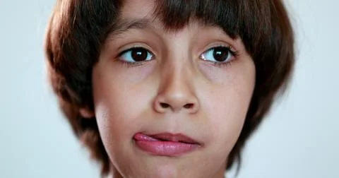 Portrait child boy thinking, close-up ethnically diverse kid looking for solu Stock Photos