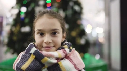 Portrait of Child Looking at Camera on Christmas Tree Background Stock Footage 71899296