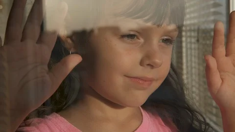 Portrait of a child looking out the window. Video stock 120400782