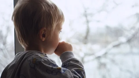 Portrait of child looking in the window. The boy face close up child through  Stock Footage 100304029
