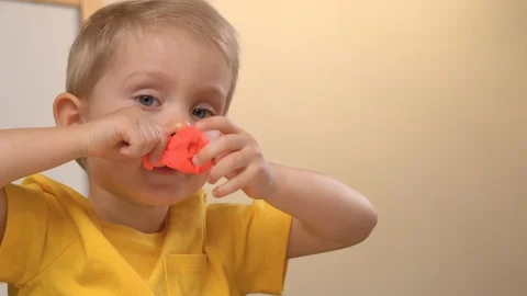 Portrait of a child playing with modeling compound (clay) Stock Footage 128065583