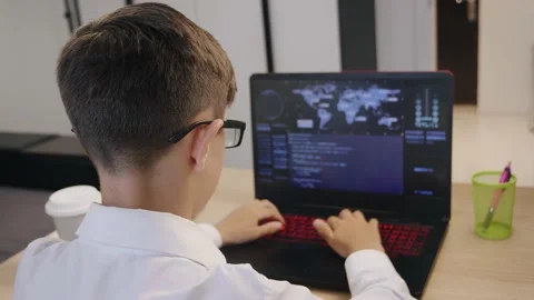 Portrait of child prodigy boy is programming the code behind a laptop at home Vidéo 133656102