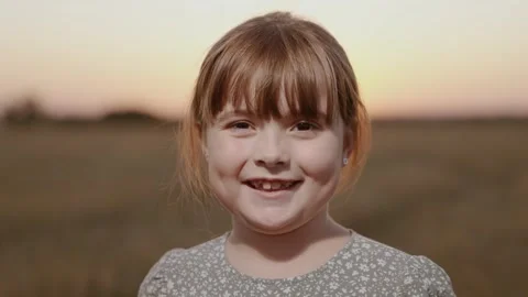 Portrait of child smiling at camera. Cute baby face, girls on outdoors close-up Stock Footage 241960945