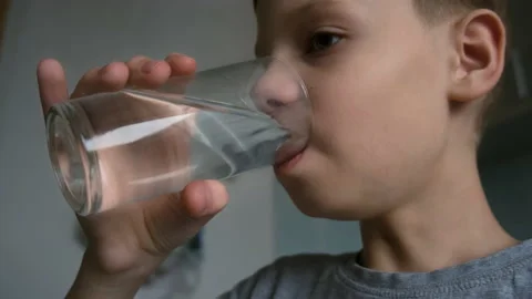 Teen boy with water, Stock image