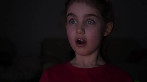 Portrait Child While Watching TV. Scared Girl Watch Television in Living Ro.. Video stock 336024687