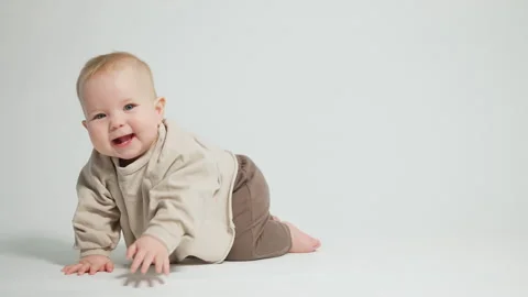 Portrait of a child who learned to crawl, video on a light studio background Stock-Footage 242769278