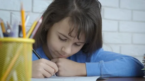 Portrait of a child writing in a notebook Stock Footage 105401226