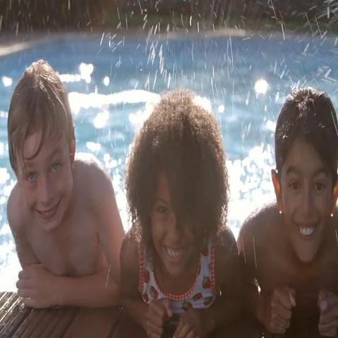 Portrait Of Children Having Fun In Outdoor Swimming Pool Stock Footage