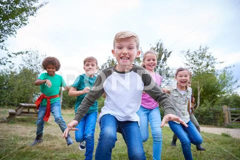 Portrait Of Children On Outdoor Activity Camping Trip Having Fun Playing Game Stock Photos